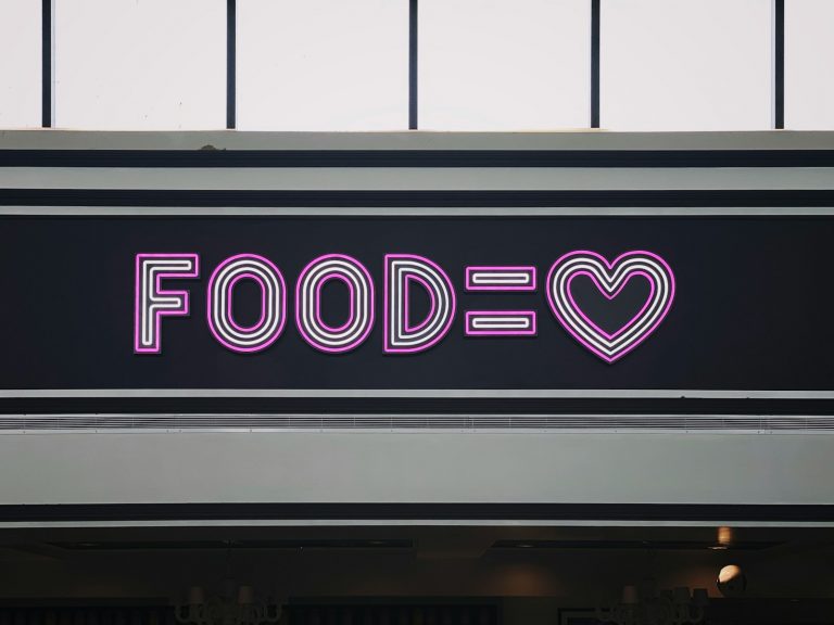 a neon sign that says foodie with a heart
