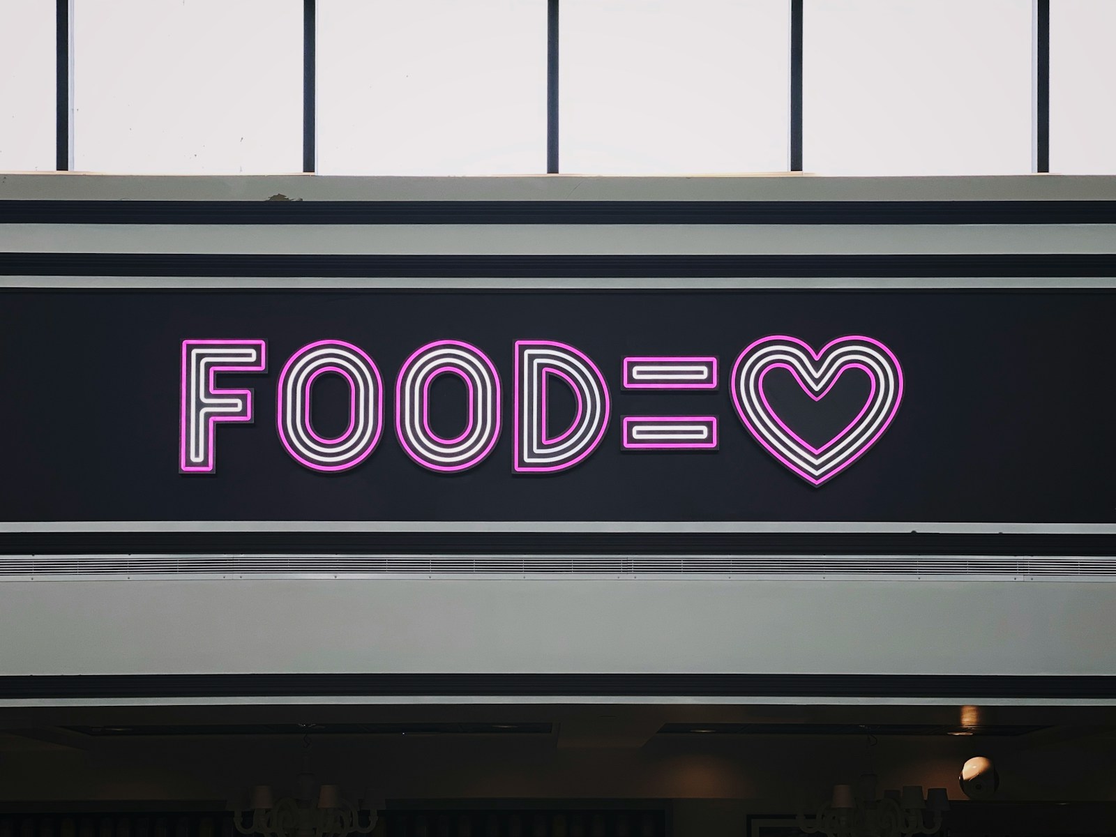 a neon sign that says foodie with a heart