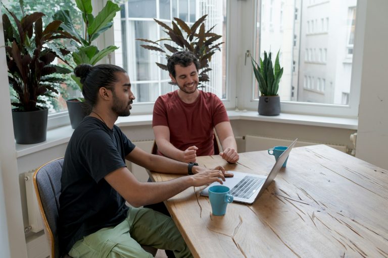 Globale Zahlungsmodelle für SaaS-Startups: Strategien für die internationale Skalierung man in black crew neck t-shirt sitting beside woman in red crew neck t-shirt