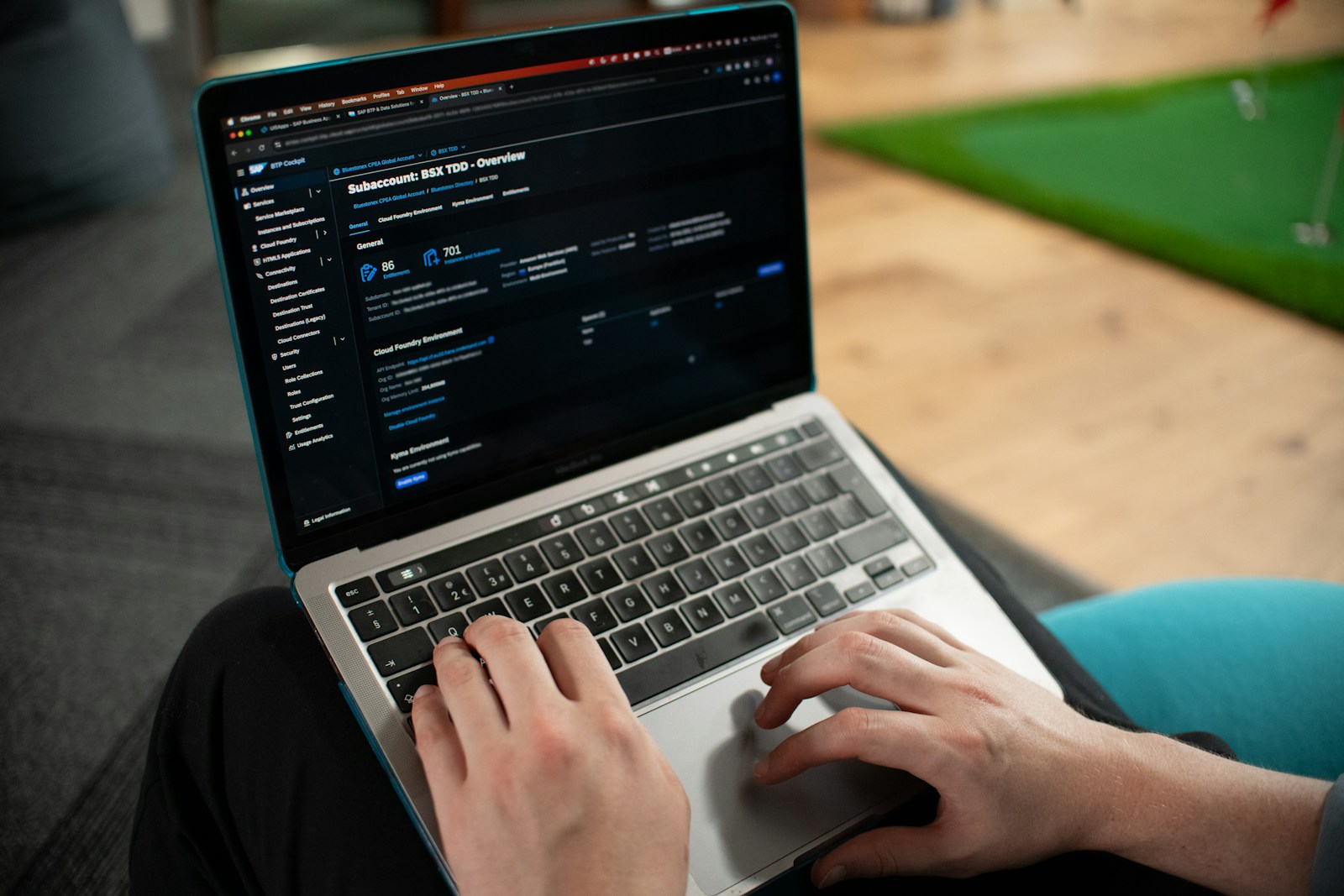 Hands typing on a laptop computer screen